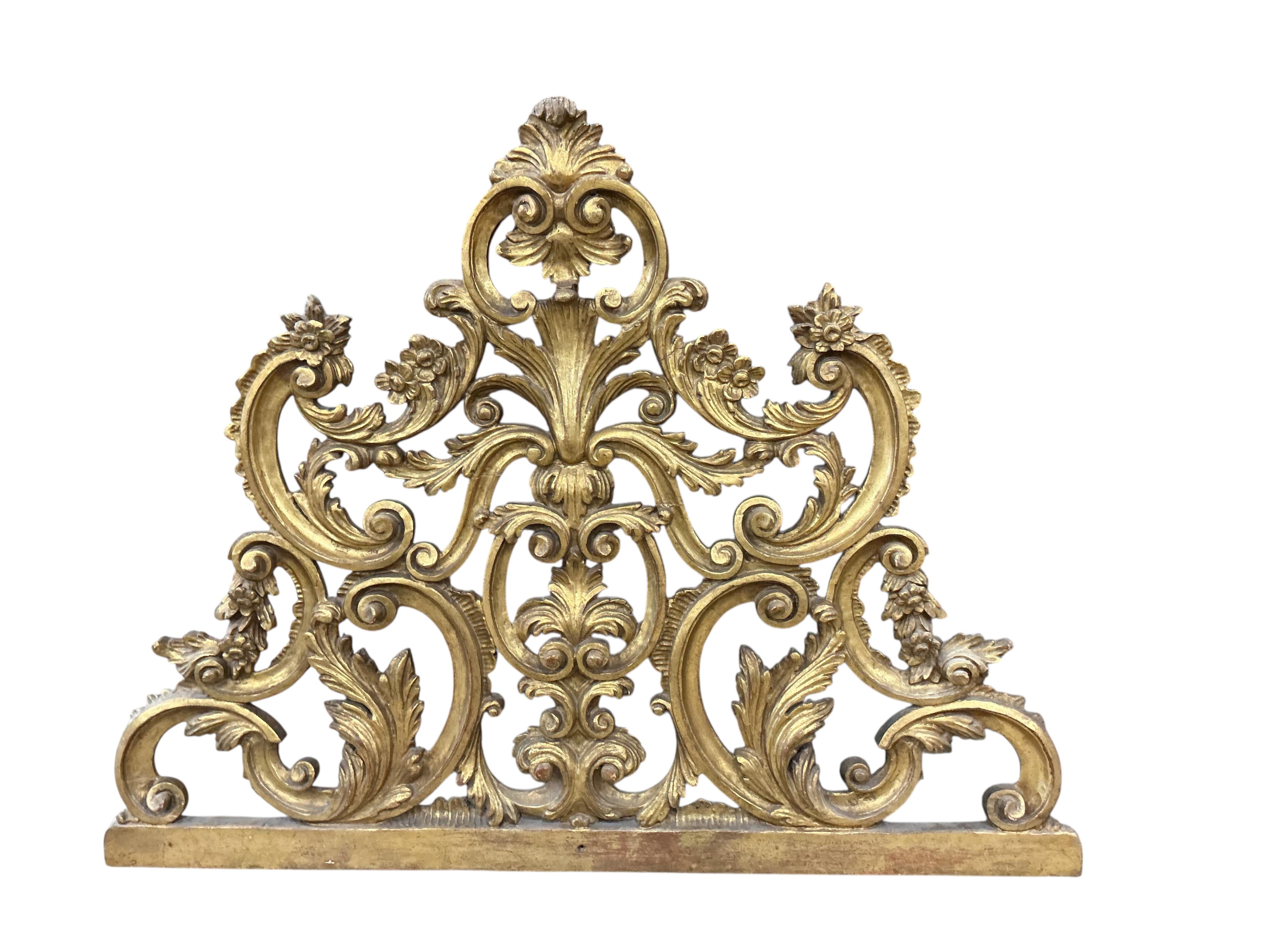 An early 20th century carved giltwood pediment, width 108cm, height 82cm
